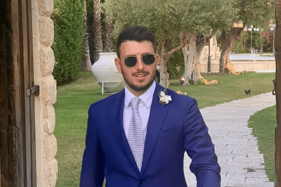 groom-wearing-tailored-wedding-suit-and-italian-bespoke-ceremony-accessories